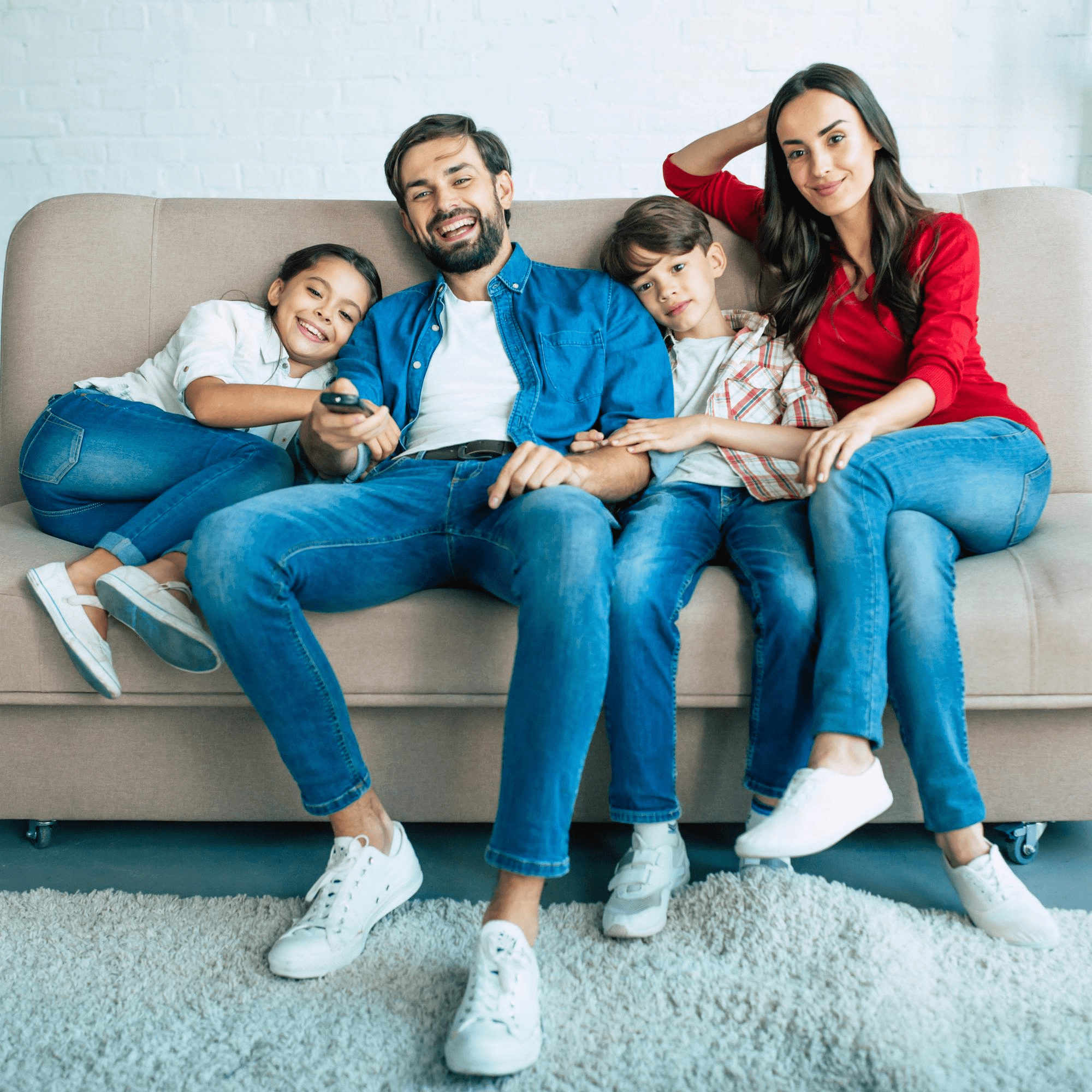 Happy Family Sitting on Sofa - iNSURA