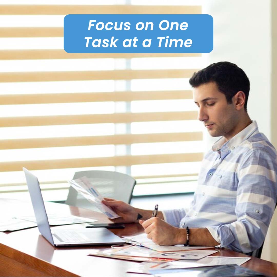 Man sitting on office table seeing paper